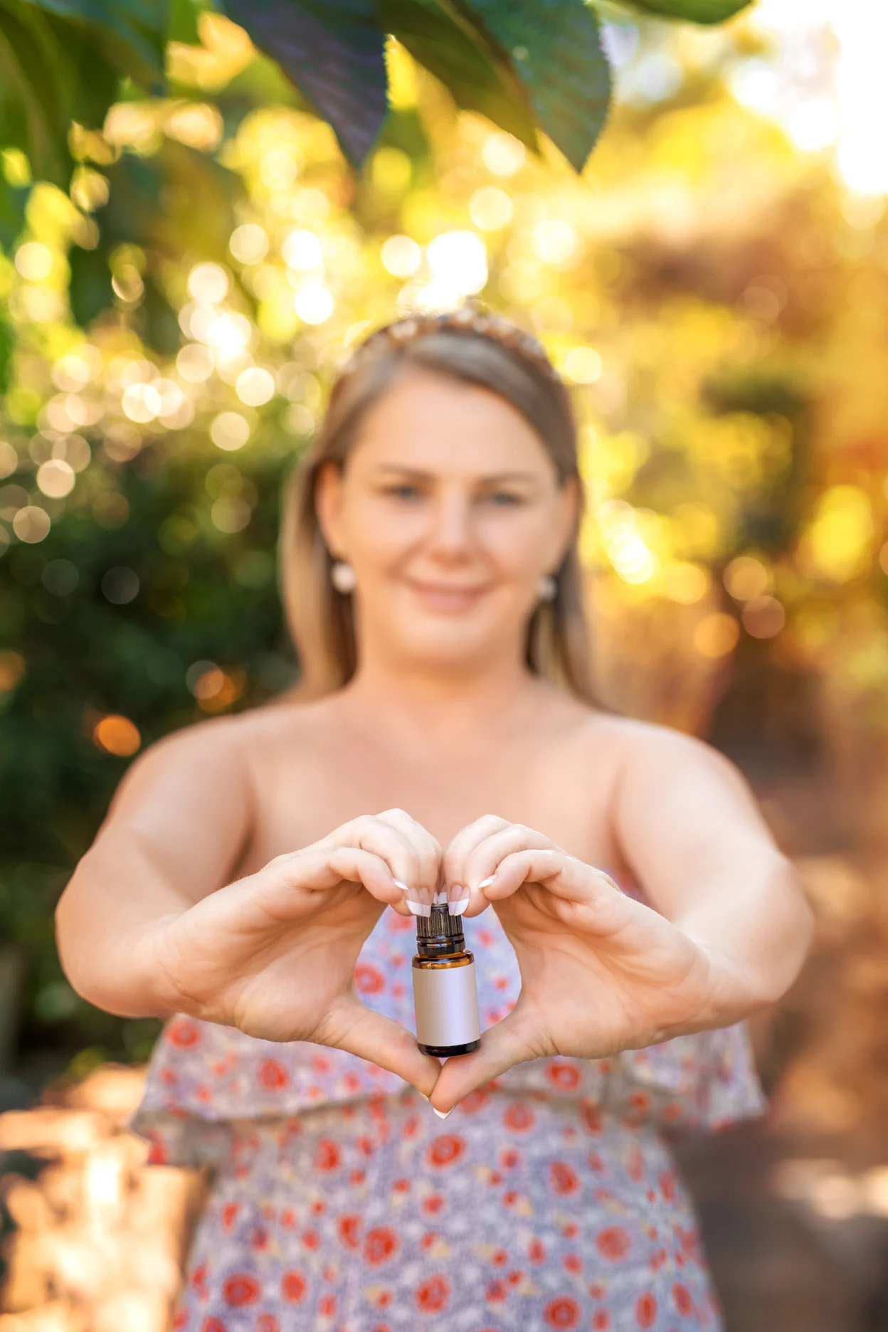 Woman Holding a Bottle of Essential Oil  