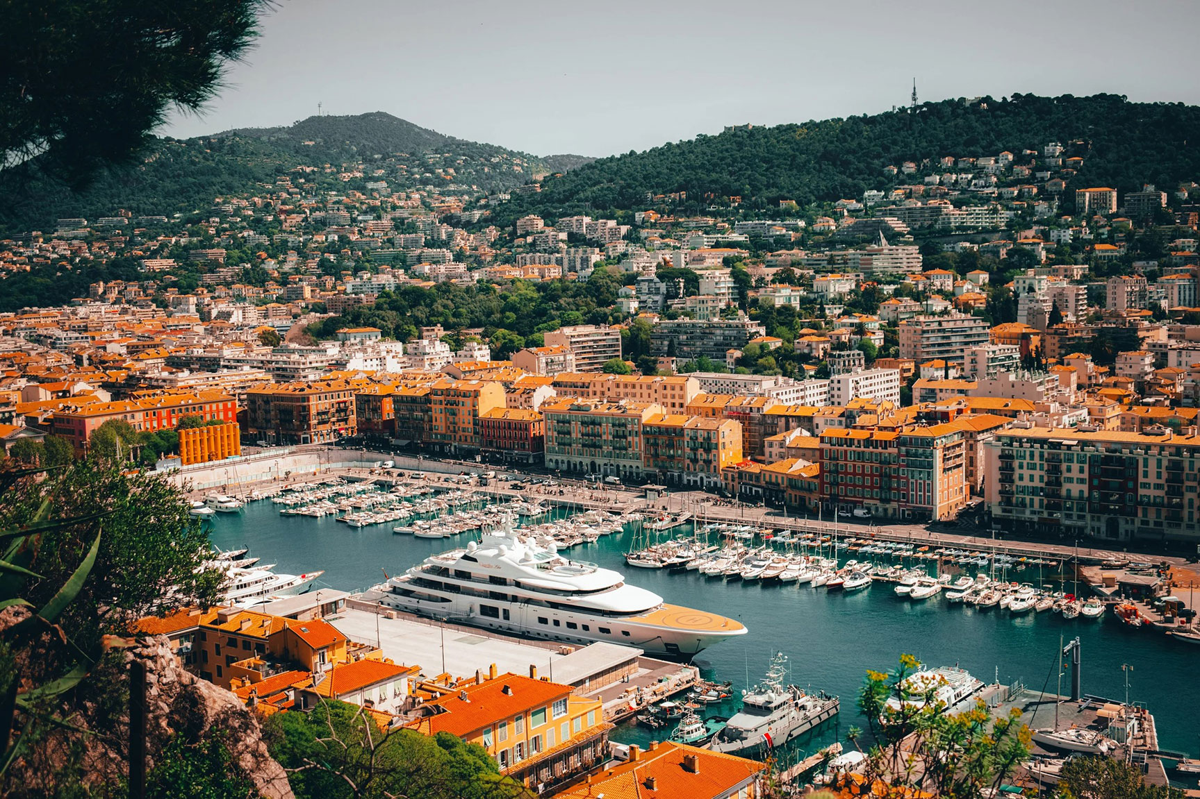 Aerial View of Watercrafts on Harbor Surrounded by City Buildings