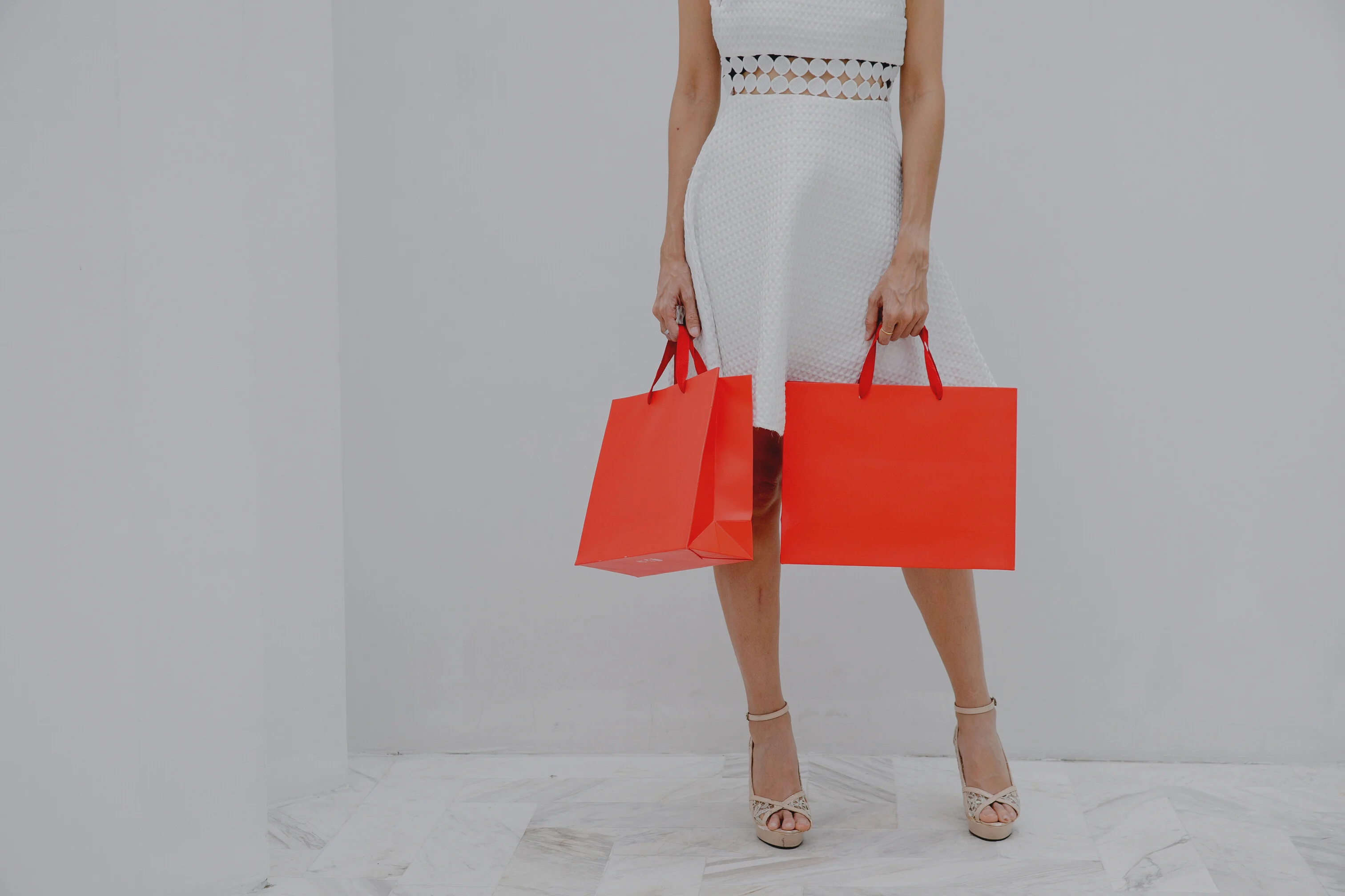 A Woman in White Dress Holding a Shopping Bag