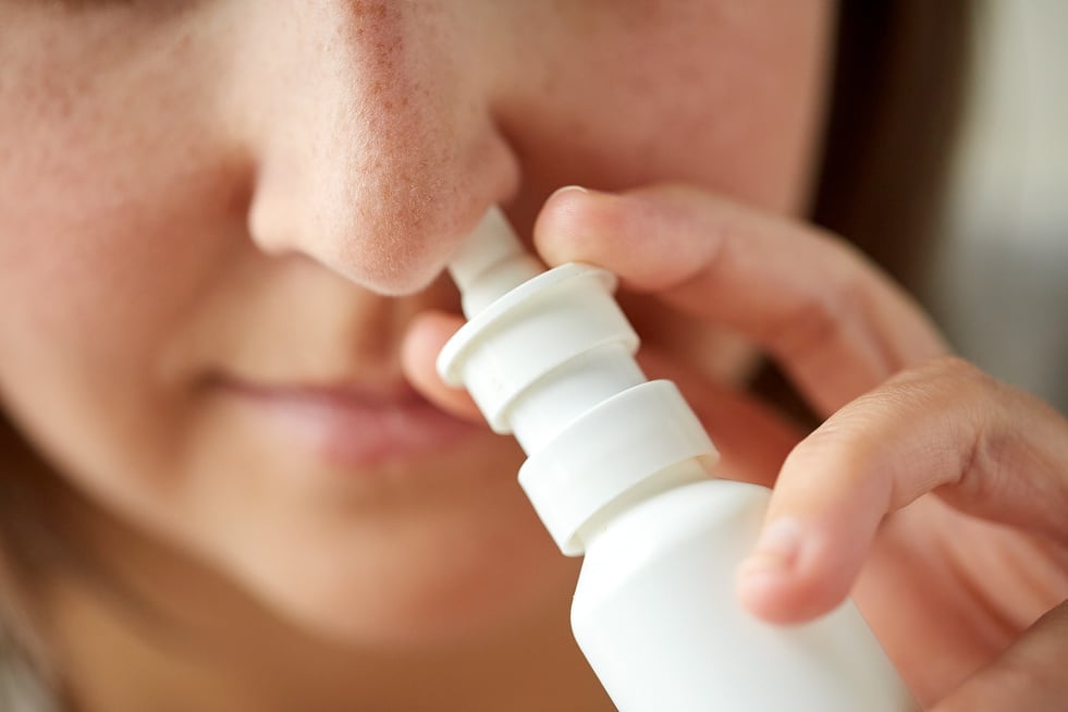 Sick Woman Using Nasal Spray