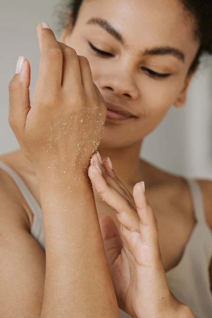 Woman Applying Scrub on Skin