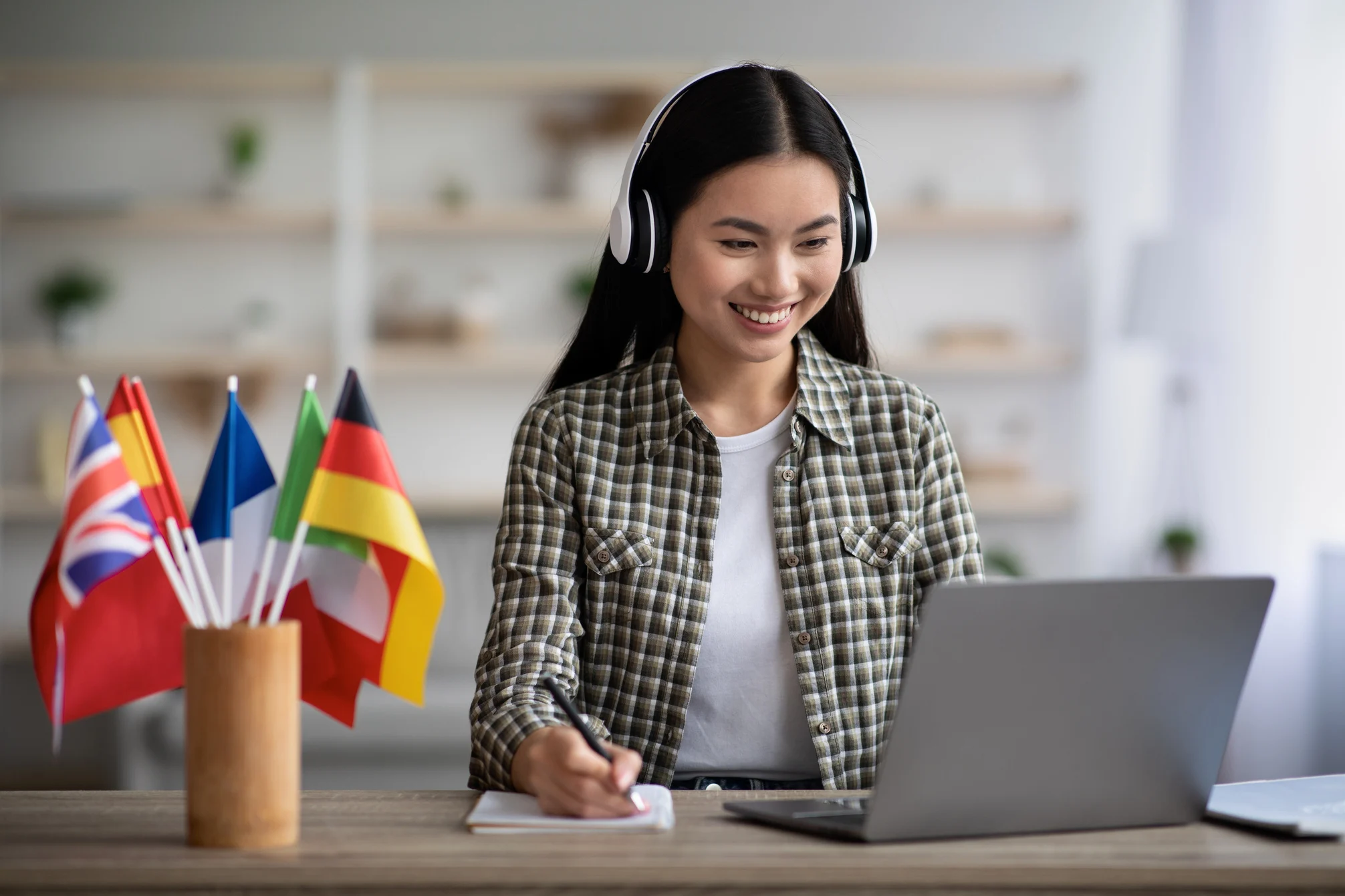 Happy asian woman learning foreign language online